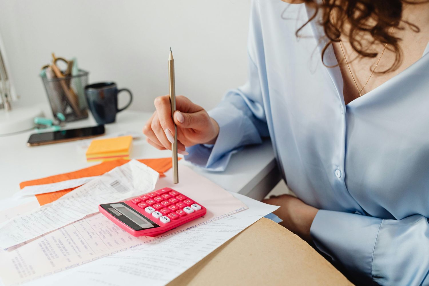 Woman working out bills with a calculator