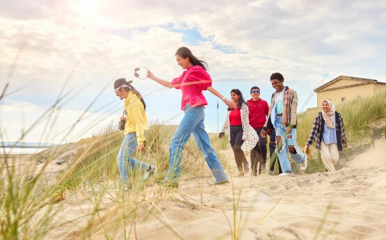 Students walking on beach