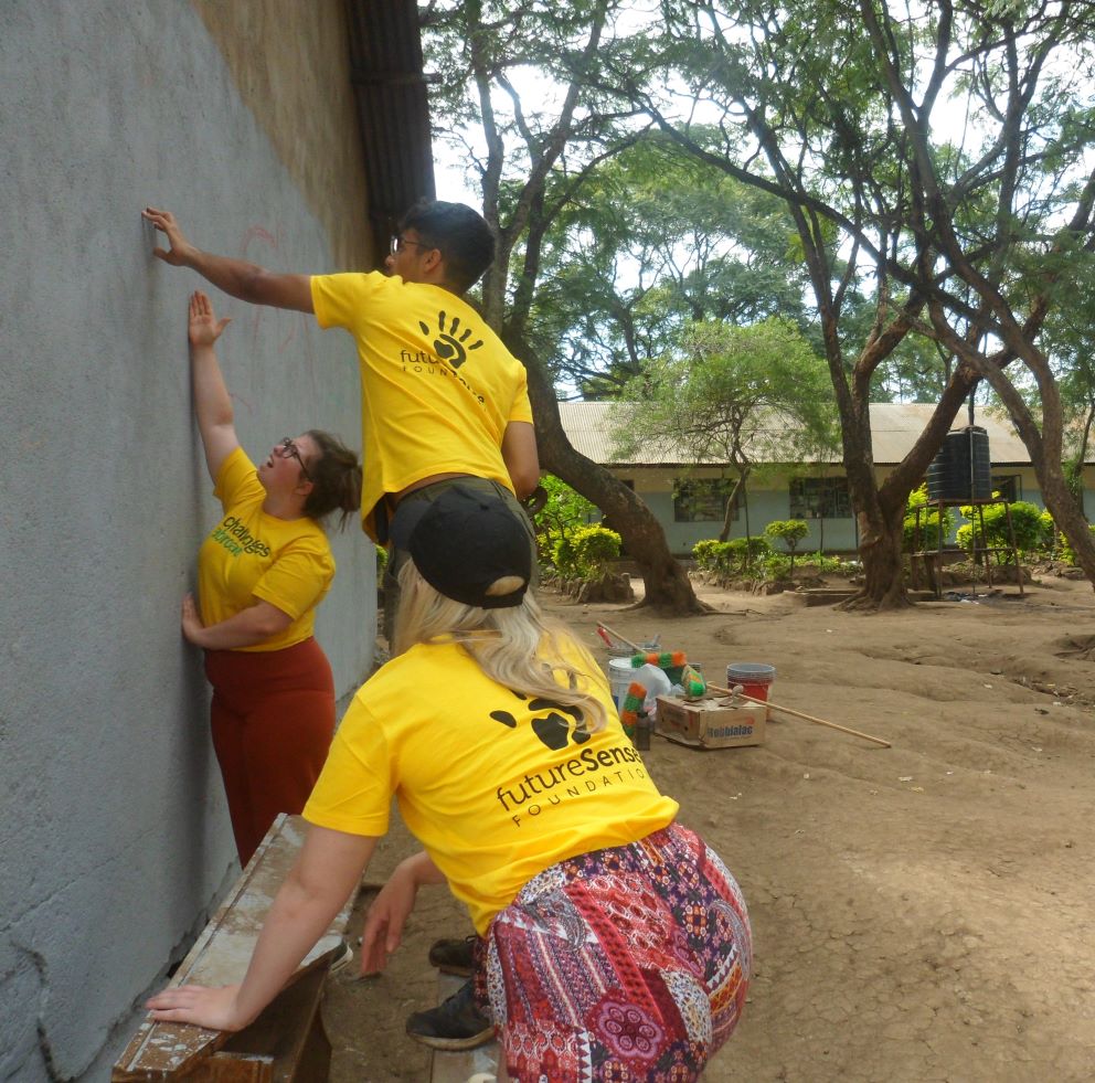 Volunteers painting a wall