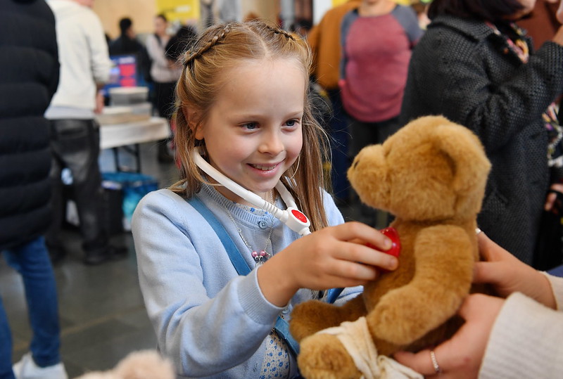 An image of a child with a teddy bear at the Swansea Science Festival.