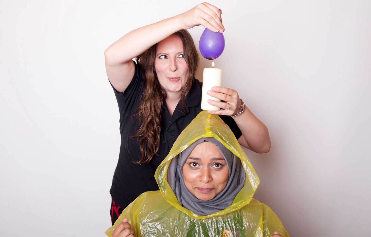 Two ladies with a candle and a balloon