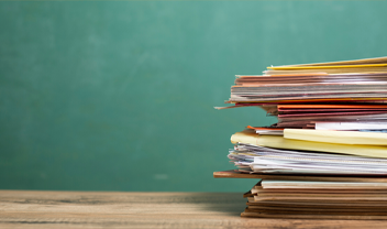 A stack of papers waiting to be marked