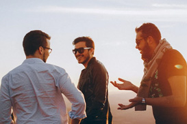 Some men talking on a beach