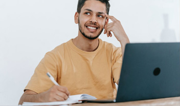 A male student thinking of what to write