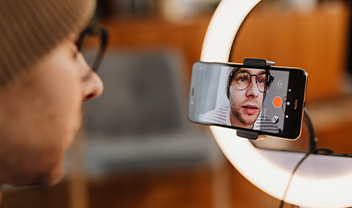 A student using a phone to film themselves