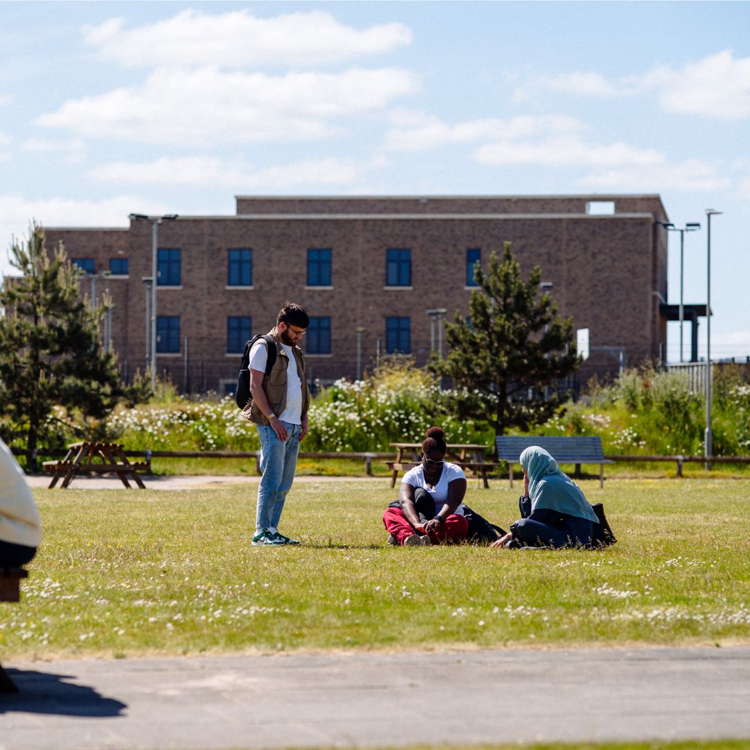 Students relaxing outside The College, Swansea University