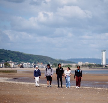 Students walking on the beach