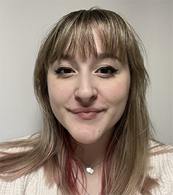 A student smiling against a white background 