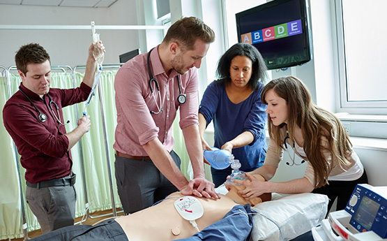 Students completing an A B C D E examination on a dummy 