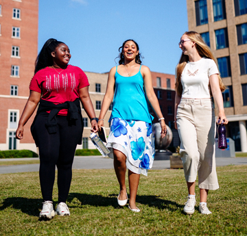 Three students walking towards the camera