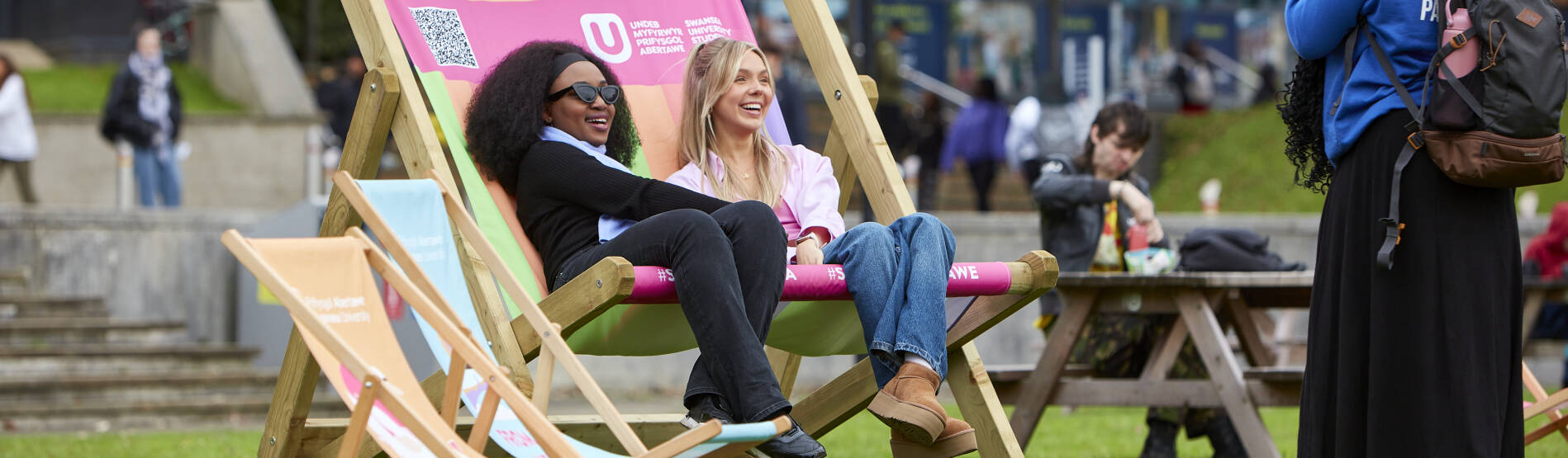 Students sat on a giant deck chair at open day