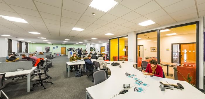 Students studying and collaborating in an open-plan learning space