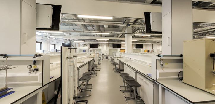 Modern chemistry laboratory with workbenches, stools and equipment