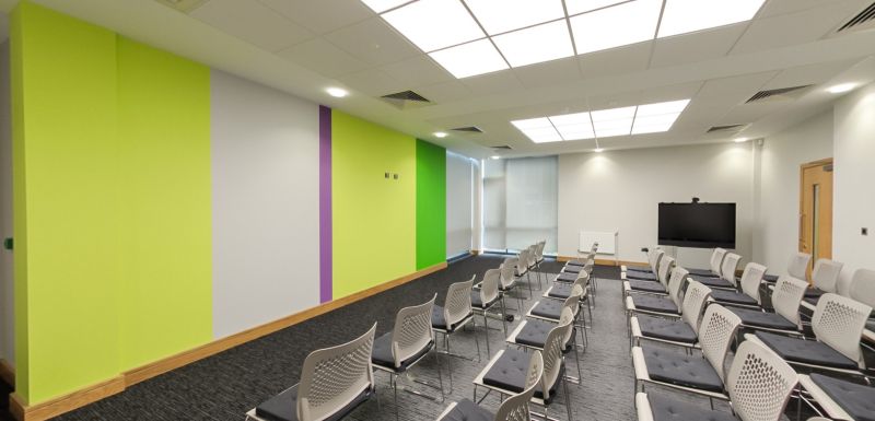 Training room with presentation screen, seating and interactive display