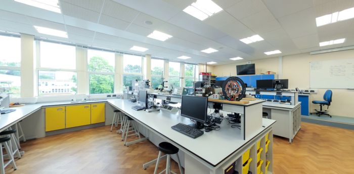 Physics teaching laboratory with workstations, computers and lab equipment