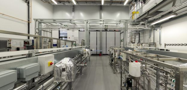 Pilot plant lab with pipes, industrial equipment, and process rigs
