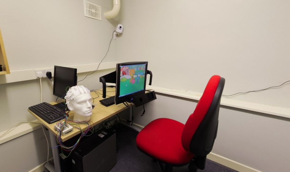 Eye-tracking research room with computer workstation and EEG equipment