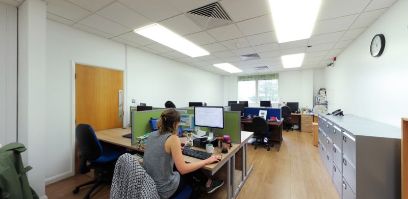 Open-plan postgraduate study area with desks, computers and study spaces