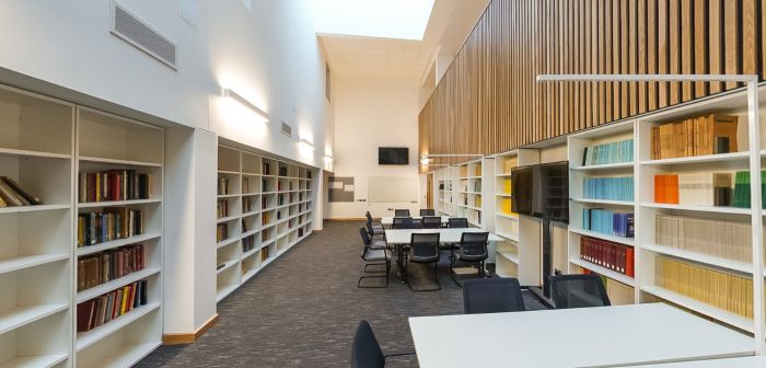 Quiet reading room with bookshelves, study tables and natural light