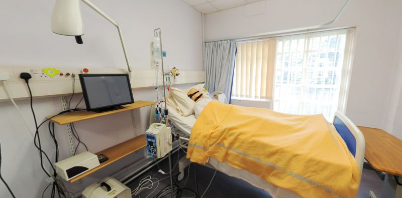 Simulation room with hospital bed, patient mannequin and monitoring equipment