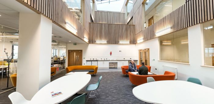 Collaborative study space with tables, lounge seating and open mezzanine